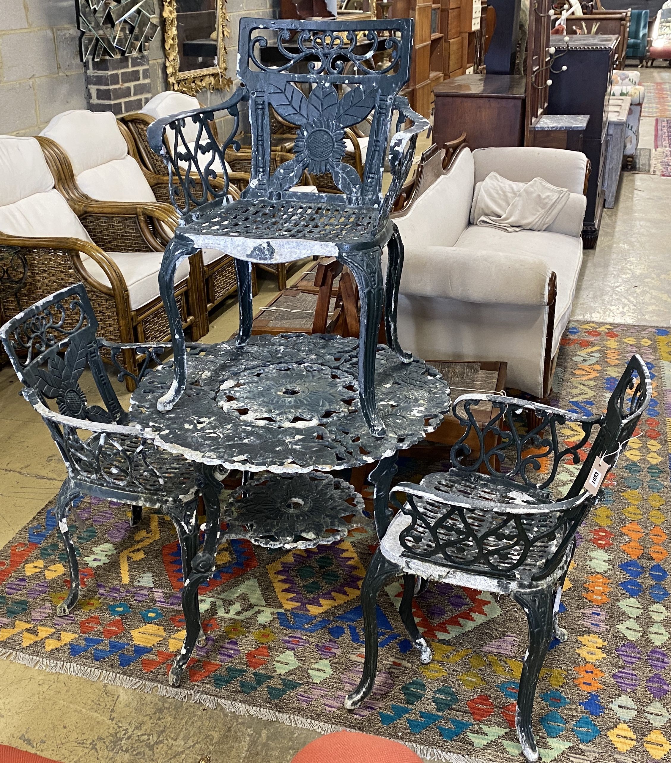 A circular painted aluminium garden table, diameter 76cm, height 70cm and three similar elbow chairs